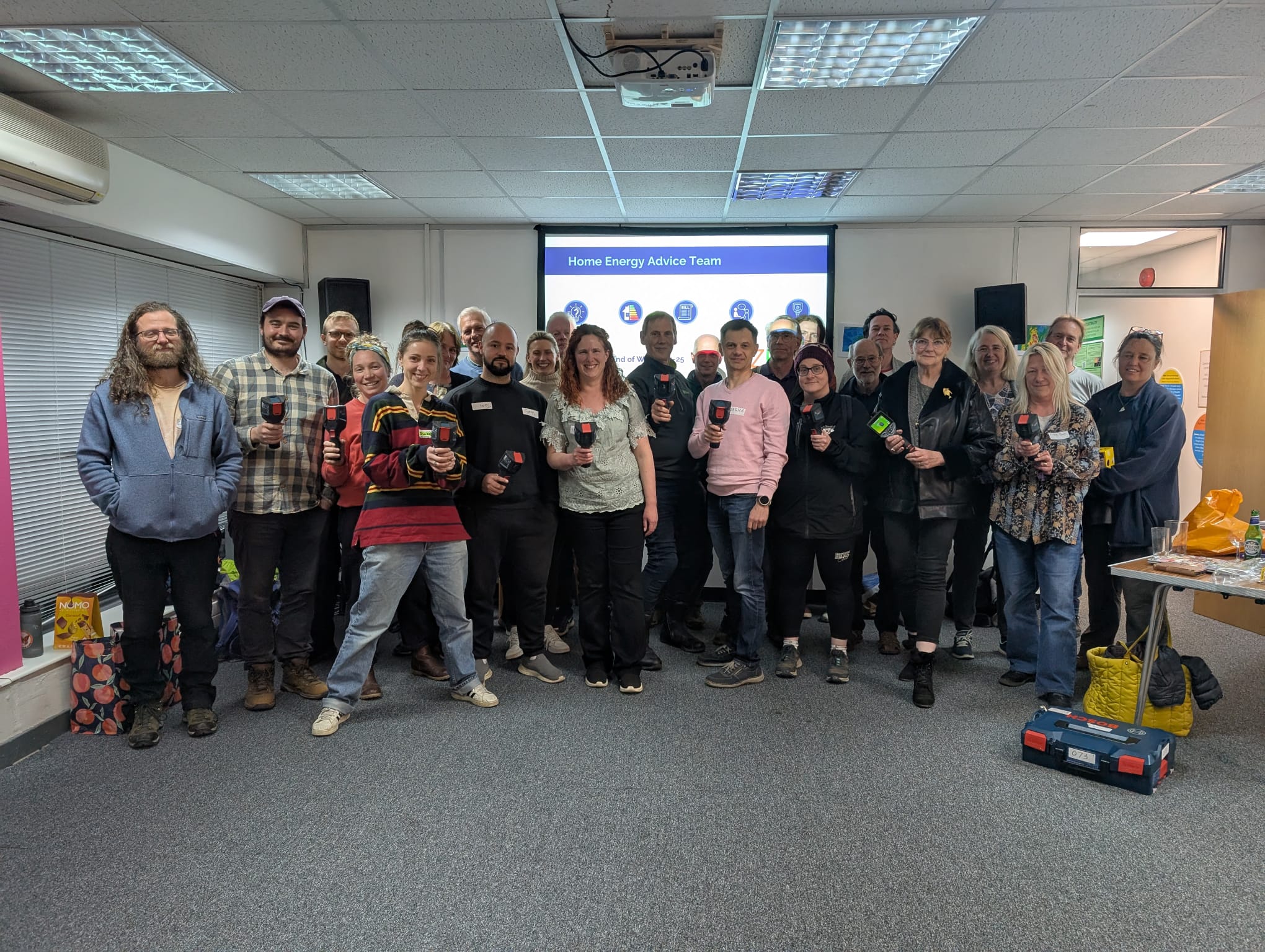 Group photo with everyone holding a thermal imagine camera.