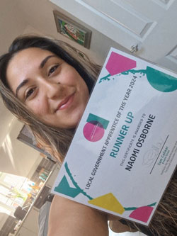 A girl smiling with AOTY certificate.
