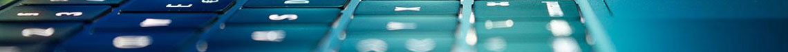 Decorative banner featuring a closeup photo of a laptop keyboard backlit in blue and green light