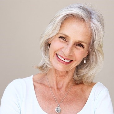 smiling woman dressed in smart clothing.