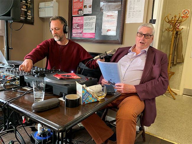 A participant and staff member taking part in the live community radio broadcast