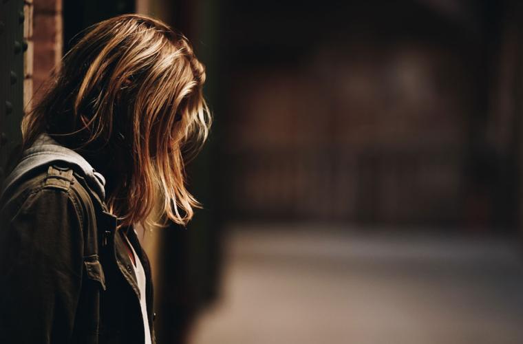 Young woman in an alleyway