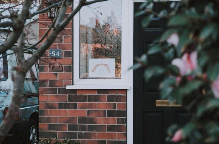 Front door of a house with a picture in the window (1500x1000)