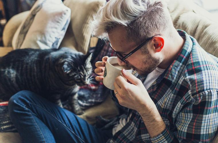 Man sitting on sofa with his cat