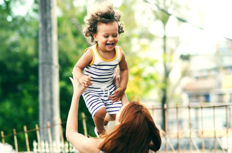 Mother lifting her child into the air