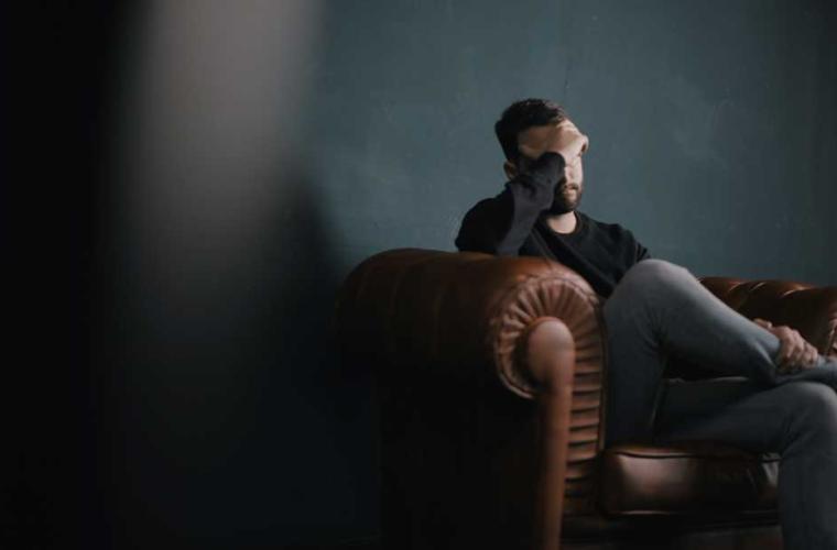 Sad man on sofa