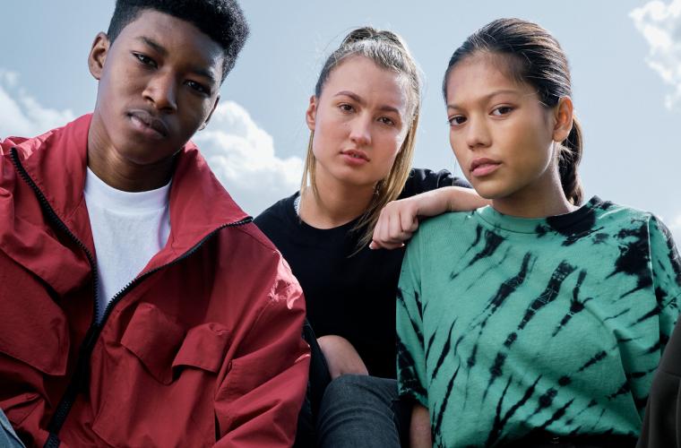 Three young people looking directly at camera