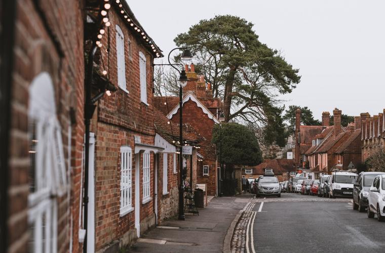 Average street in the UK featuring a number of houses and some cars