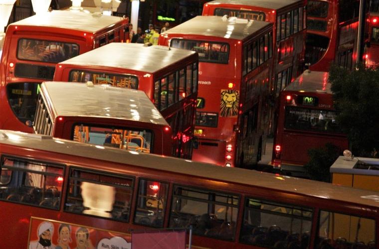 red double decker bus on road in night time