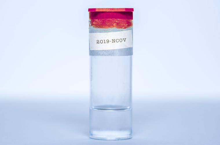A glass vial with a red lid and a label saying '2019-NCOV'