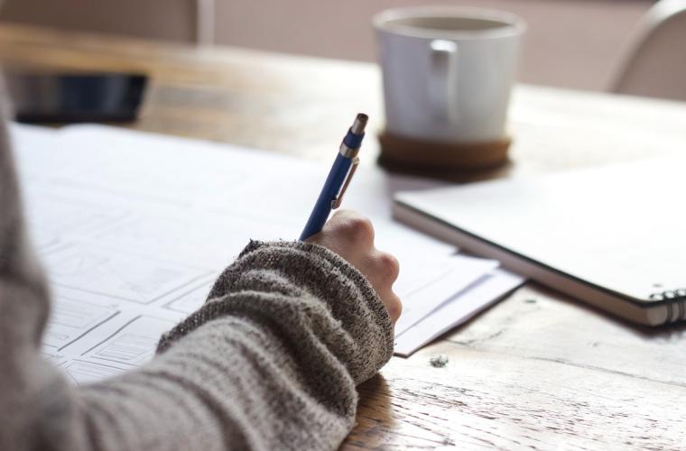 Person writing on a page