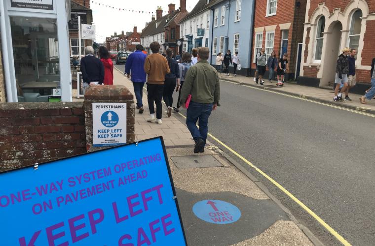 High street in East Suffolk with a few people walking through