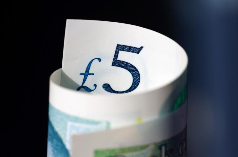 A five pound note rolled up