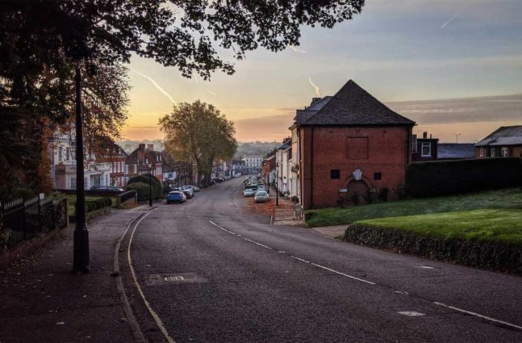 street scene - houses set back from road with sunset