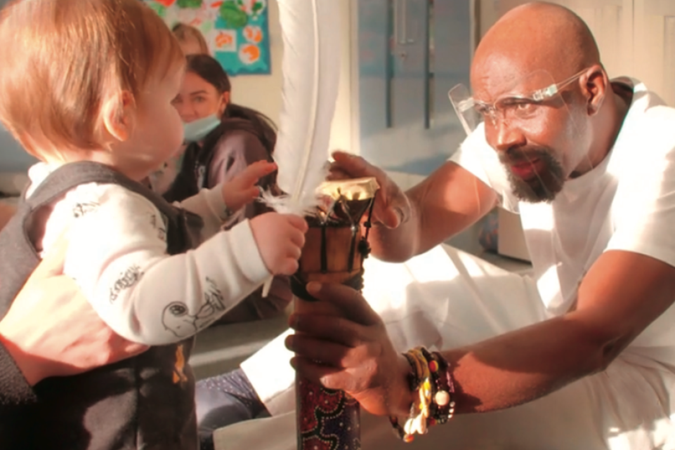 Toddler playing with artist 