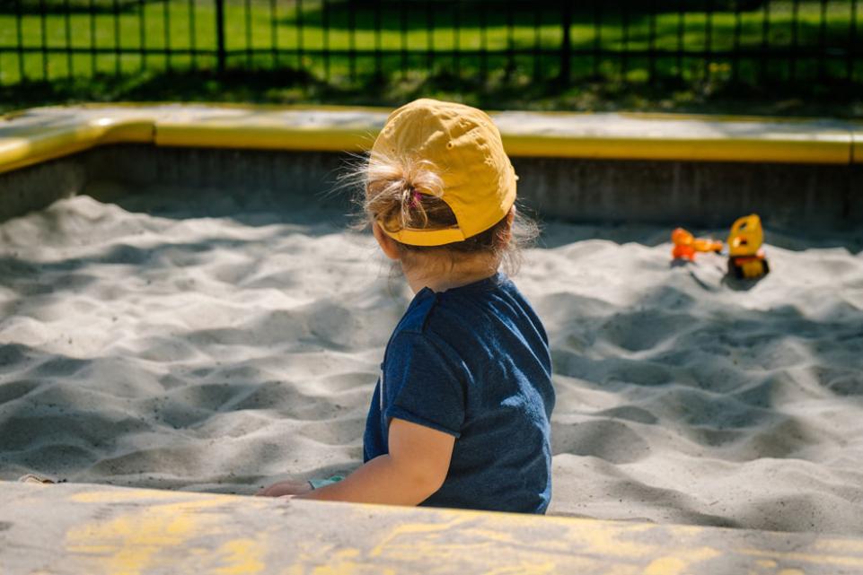 Toddler playing in a sandbox