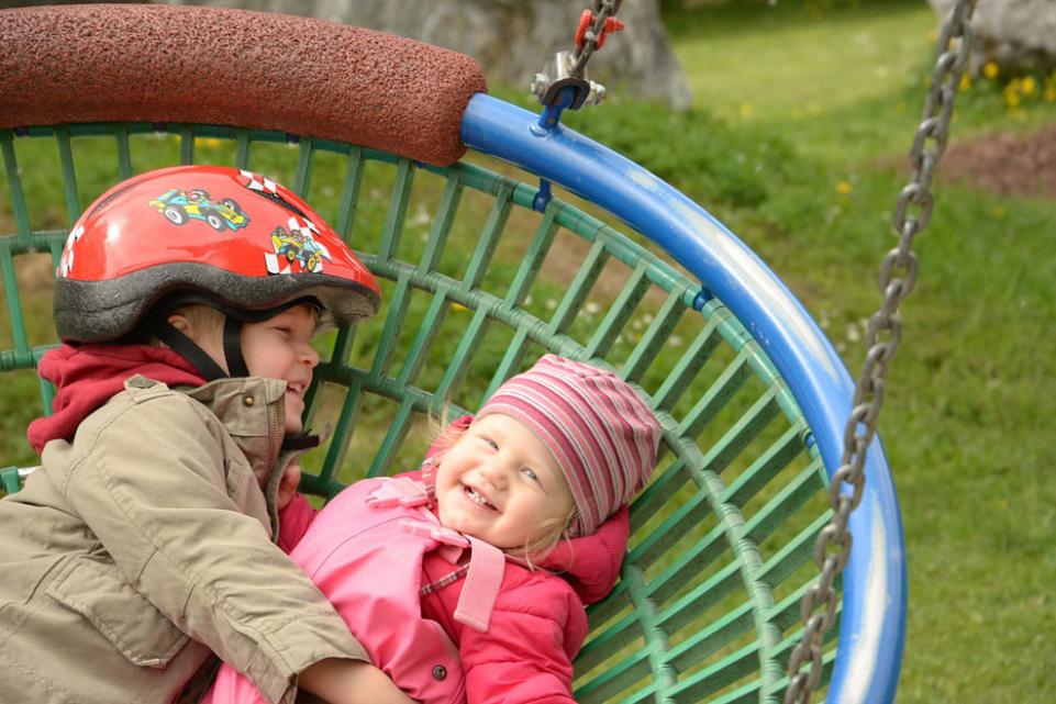  Toddlers playing on a big swing