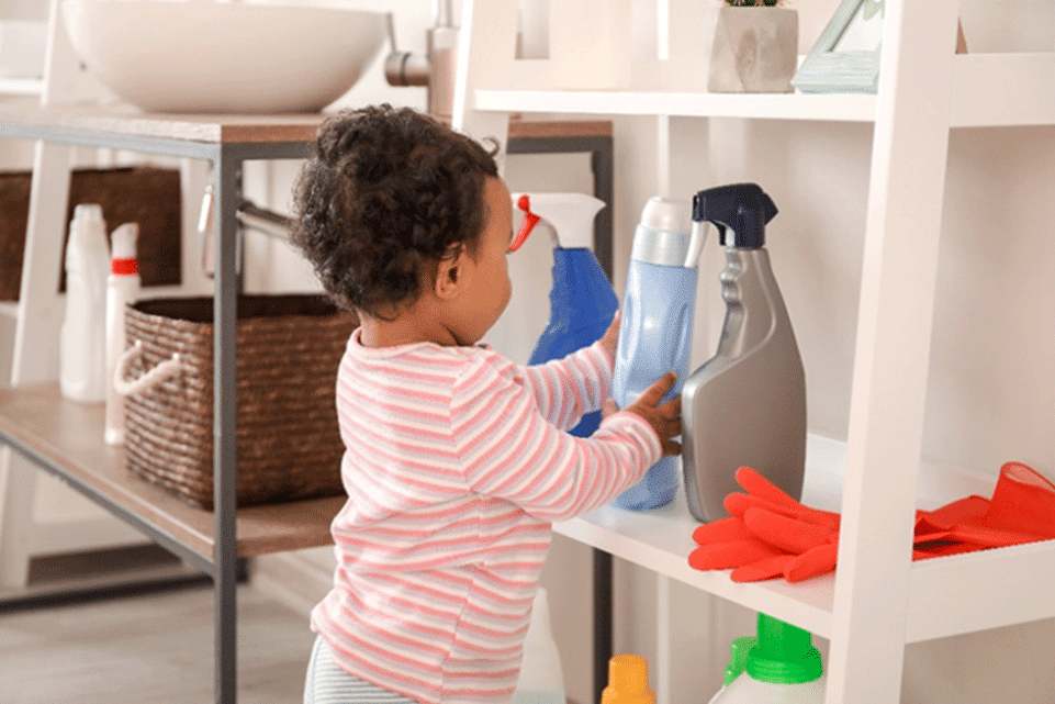 Toddler examining a plastic container