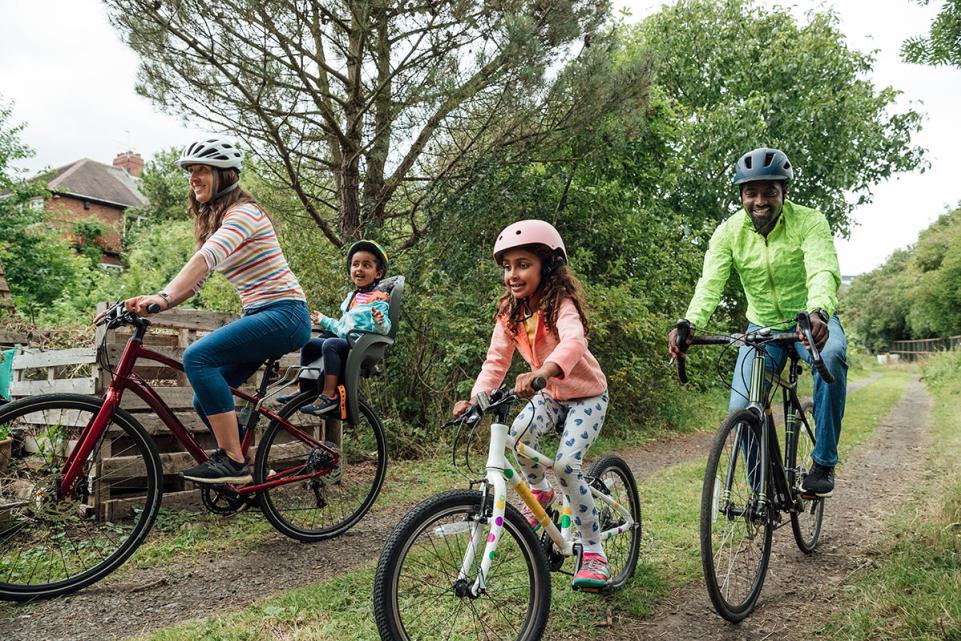 Young-family-cycling-along-country-lane