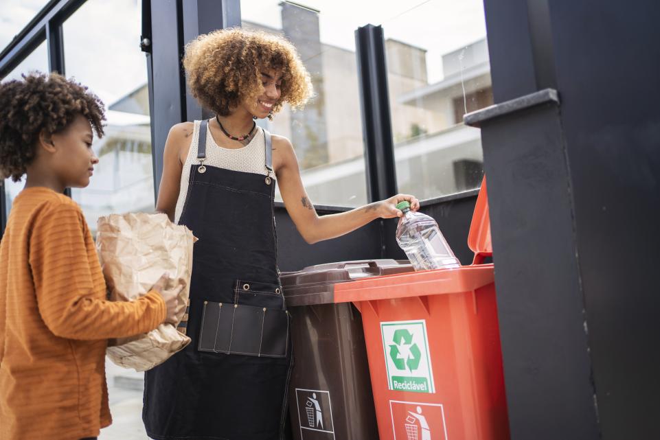 People using a recycling bin