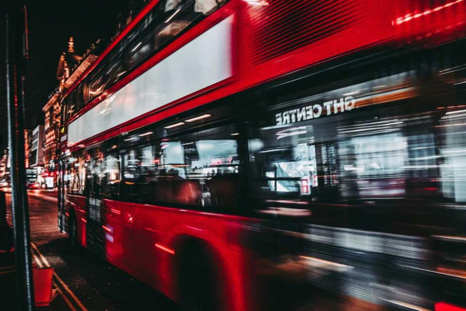 red bus at night time 